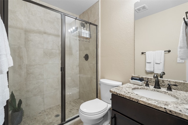8208 Burleigh St, Frisco, TX 75035 - bathroom featuring vanity, toilet, a stall shower, and a textured wall