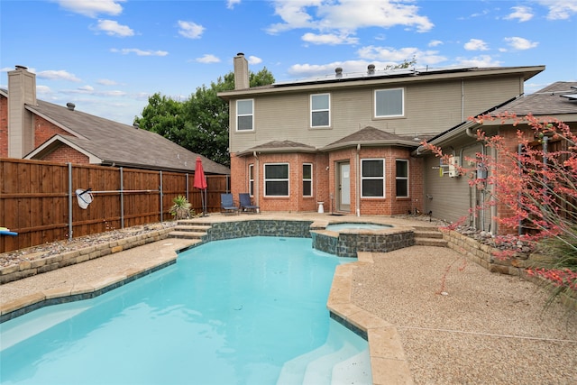 8208 Burleigh St, Frisco, TX 75035 - back of house featuring roof mounted solar panels, a fenced backyard, a patio area, brick siding, and a chimney