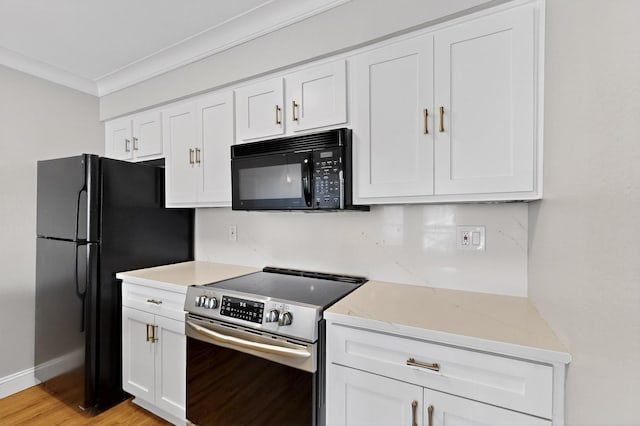 5919 E University Blvd Unit 238, Dallas, TX 75206 - kitchen with black appliances, white cabinetry, ornamental molding, light stone countertops, and light wood finished floors