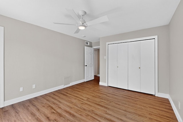 5919 E University Blvd Unit 238, Dallas, TX 75206 - unfurnished bedroom featuring light wood finished floors, baseboards, a closet, and ceiling fan
