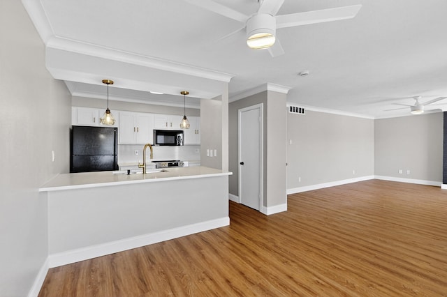 5919 E University Blvd Unit 238, Dallas, TX 75206 - kitchen featuring black appliances, a ceiling fan, crown molding, wood finished floors, and baseboards
