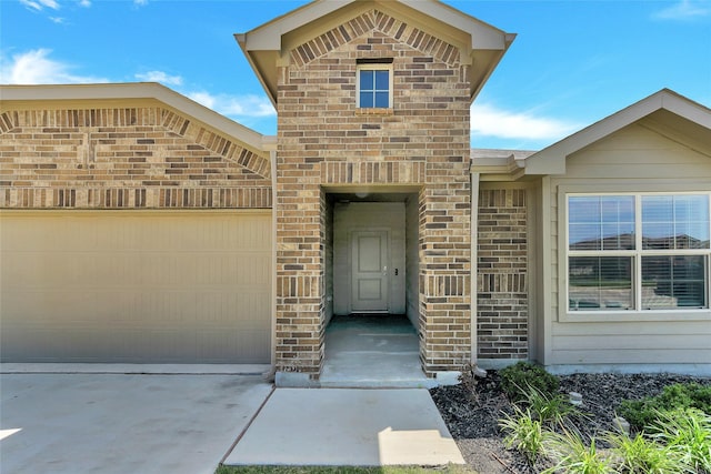 16608 Portage St, Justin, TX 76247 - entrance to property featuring a garage, concrete driveway, and brick siding