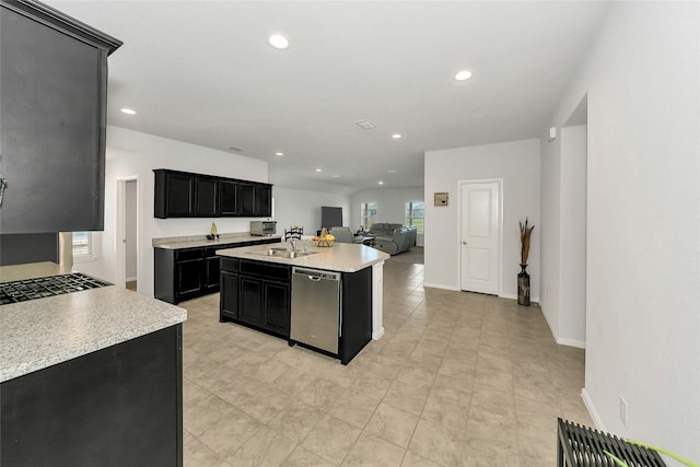 16608 Portage St, Justin, TX 76247 - kitchen with dark cabinetry, stainless steel dishwasher, light countertops, open floor plan, and recessed lighting