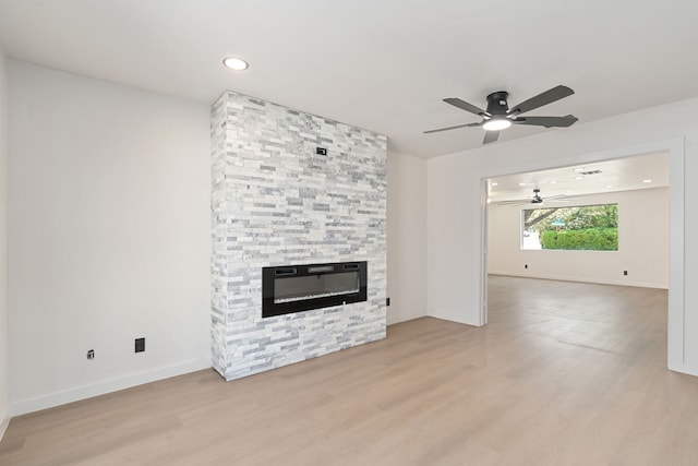 2305 Fenestra Dr, Dallas, TX 75228 - unfurnished living room featuring ceiling fan, light wood finished floors, a stone fireplace, and recessed lighting