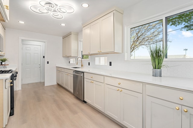 2305 Fenestra Dr, Dallas, TX 75228 - kitchen featuring dishwasher, black range oven, healthy amount of natural light, and recessed lighting