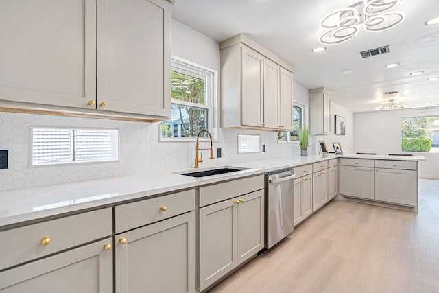 2305 Fenestra Dr, Dallas, TX 75228 - kitchen with stainless steel dishwasher, light wood finished floors, light countertops, a peninsula, and recessed lighting