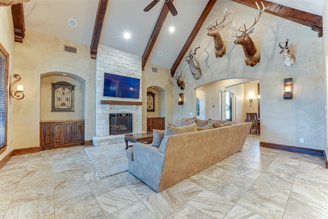 2412 Versailles Dr, Heath, TX 75032 - living area featuring beamed ceiling, high vaulted ceiling, marble finish flooring, a fireplace, and arched walkways