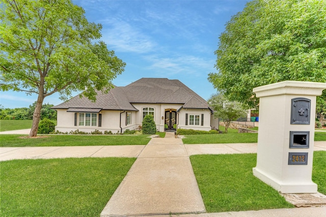 2412 Versailles Dr, Heath, TX 75032 - french country style house with stucco siding, a front lawn, roof with shingles, and french doors