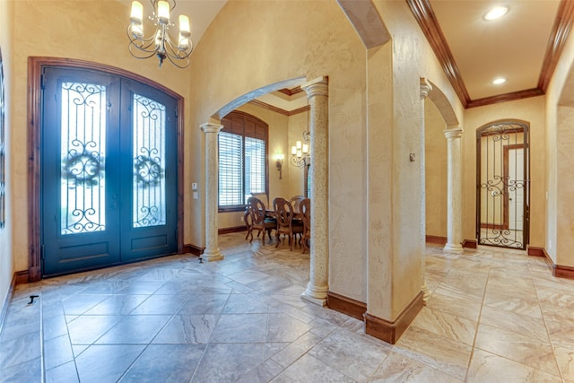 2412 Versailles Dr, Heath, TX 75032 - entryway with arched walkways, french doors, a chandelier, ornamental molding, and a textured wall
