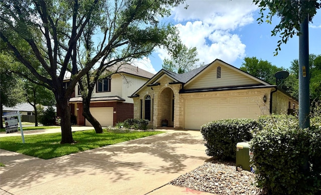 12804 Council Bluff Dr, Austin, TX 78727 - traditional home featuring driveway, stone siding, a garage, and a front lawn