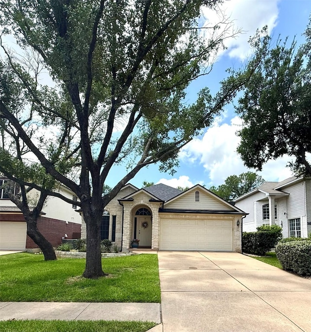 12804 Council Bluff Dr, Austin, TX 78727 - view of front of home with concrete driveway, an attached garage, a front lawn, and brick siding