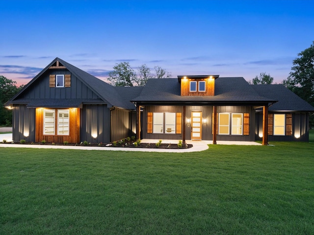 1705 J E, Woody, Springtown, TX 76082 - back of property at dusk with a yard and board and batten siding