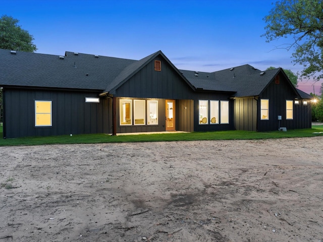 1705 J E, Woody, Springtown, TX 76082 - back of property at dusk featuring board and batten siding and a shingled roof
