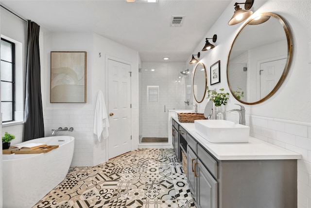 413 Timberlake Dr, Azle, TX 76020 - bathroom with tile walls, double vanity, a freestanding bath, tile patterned floors, and a shower stall