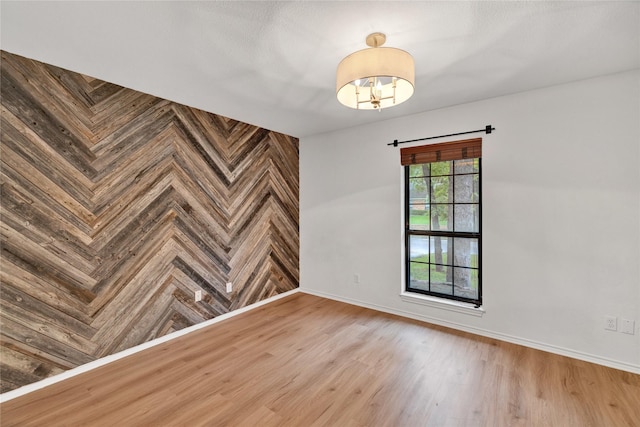 413 Timberlake Dr, Azle, TX 76020 - unfurnished room with baseboards, wood finished floors, and a chandelier