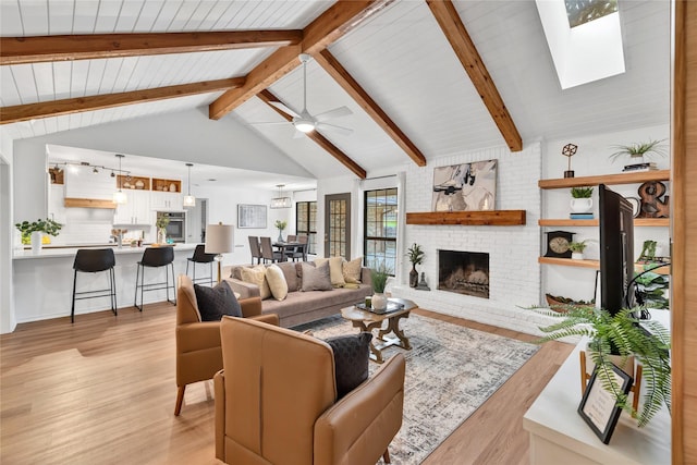 413 Timberlake Dr, Azle, TX 76020 - living room featuring light wood-style floors, a fireplace, a ceiling fan, a skylight, and wooden ceiling