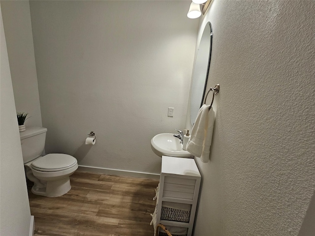 1836 Summer Aura, Mesquite, TX 75181 - half bath featuring wood finished floors, toilet, vanity, and baseboards