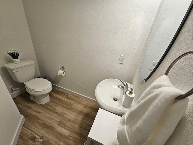 1836 Summer Aura, Mesquite, TX 75181 - bathroom featuring a sink, toilet, wood finished floors, and baseboards