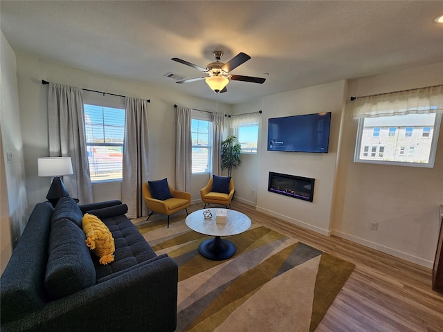 1836 Summer Aura, Mesquite, TX 75181 - living area with wood finished floors, baseboards, a glass covered fireplace, and ceiling fan