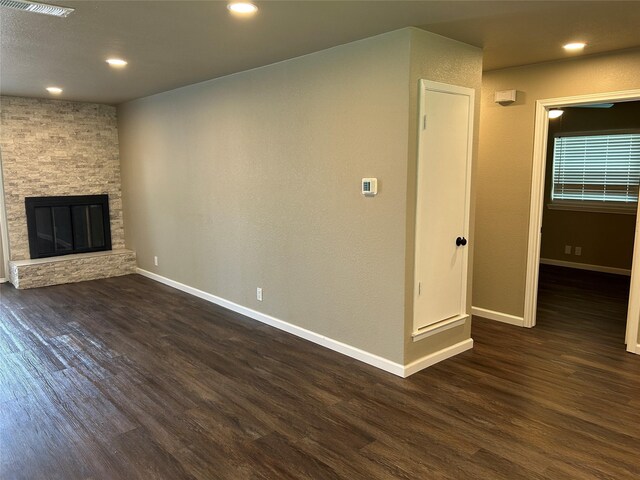 3837 Burning Tree Ln, Garland, TX 75042 - unfurnished living room featuring dark wood-type flooring, baseboards, a fireplace, and recessed lighting