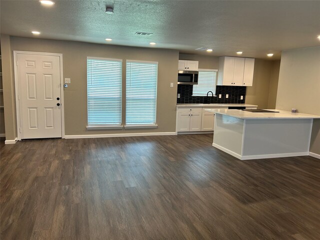 3837 Burning Tree Ln, Garland, TX 75042 - kitchen with a sink, baseboards, stainless steel appliances, tasteful backsplash, and dark wood-style floors