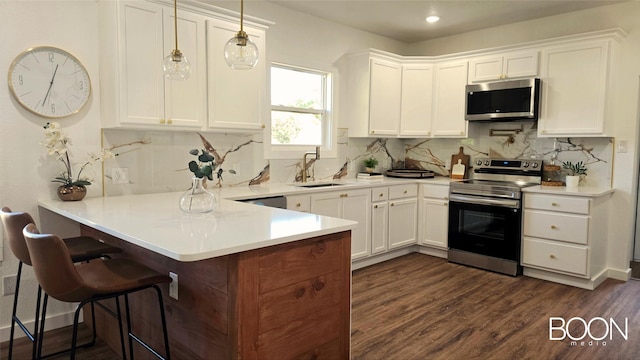 1742 S 5th St, Abilene, TX 79602 - kitchen featuring appliances with stainless steel finishes, a sink, a peninsula, white cabinetry, and backsplash