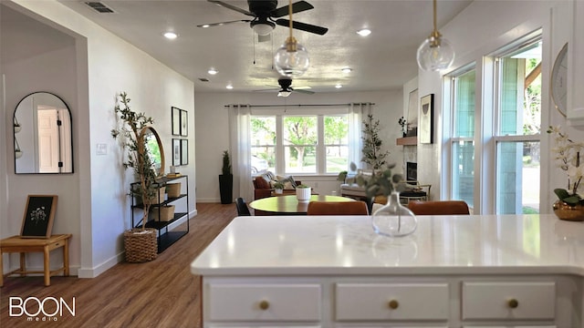 1742 S 5th St, Abilene, TX 79602 - kitchen with ceiling fan, wood finished floors, white cabinetry, recessed lighting, and baseboards