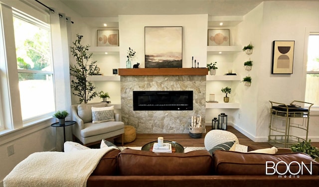 1742 S 5th St, Abilene, TX 79602 - living room with wood finished floors, plenty of natural light, and a stone fireplace