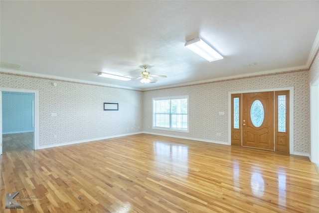 13063 Rainey Ridge Ln, Abilene, TX 79602 - entrance foyer featuring crown molding, light wood finished floors, wallpapered walls, ceiling fan, and baseboards