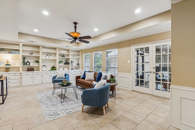 1094 Edith Cir, Richardson, TX 75080 - living room with ceiling fan, wainscoting, recessed lighting, french doors, and a decorative wall