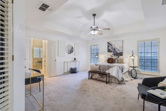 1094 Edith Cir, Richardson, TX 75080 - carpeted bedroom featuring a raised ceiling, a ceiling fan, ensuite bath, and baseboards