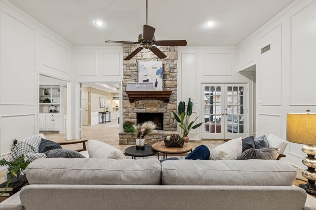 1094 Edith Cir, Richardson, TX 75080 - living area with ceiling fan, a decorative wall, built in features, recessed lighting, and a stone fireplace