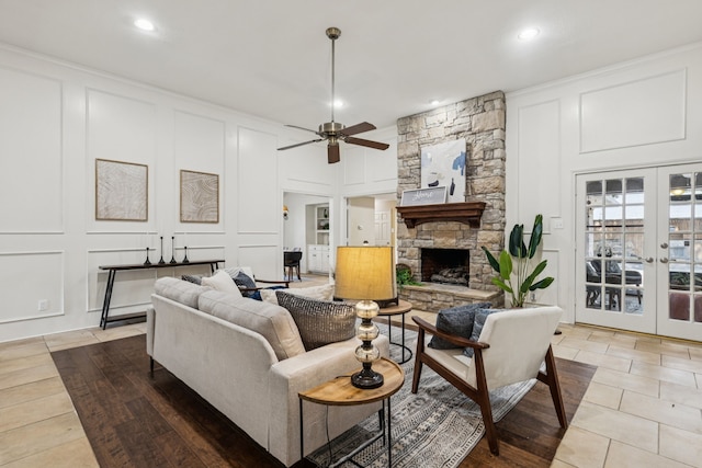 1094 Edith Cir, Richardson, TX 75080 - living room featuring a decorative wall, a ceiling fan, recessed lighting, a stone fireplace, and french doors