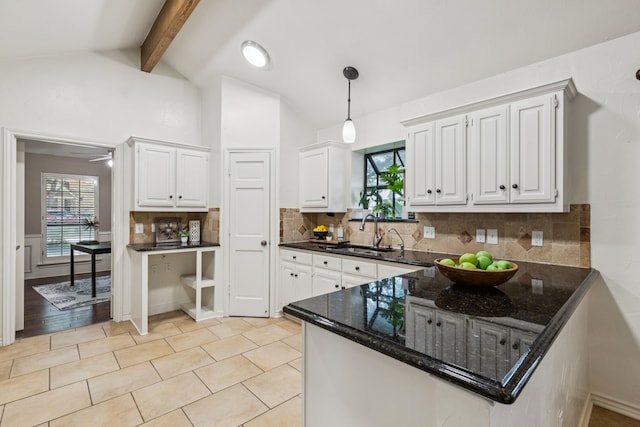 1094 Edith Cir, Richardson, TX 75080 - kitchen featuring a sink, white cabinetry, tasteful backsplash, dark stone countertops, and hanging light fixtures