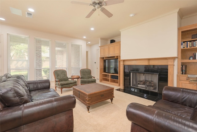 906 Glen Rose Dr, Allen, TX 75013 - carpeted living room with ornamental molding, a ceiling fan, a tiled fireplace, and recessed lighting