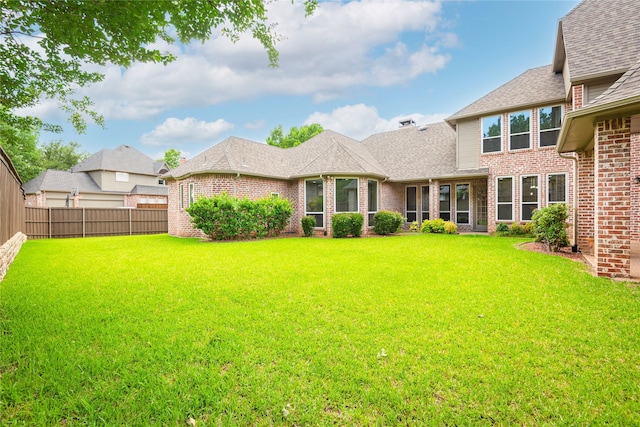 906 Glen Rose Dr, Allen, TX 75013 - back of house with brick siding and roof with shingles