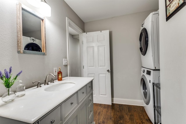 409 N Arizona, Celina, TX 75009 - bathroom featuring stacked washer and clothes dryer, wood finished floors, vanity, and baseboards
