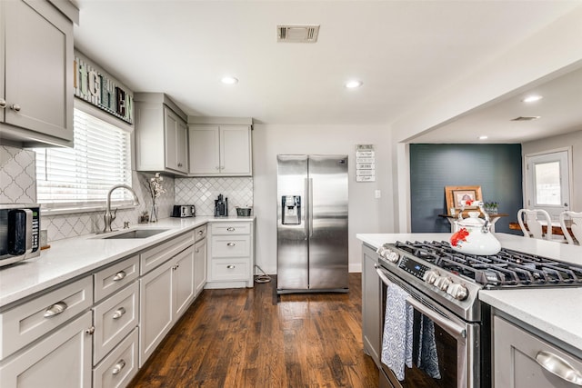 409 N Arizona, Celina, TX 75009 - kitchen featuring stainless steel appliances, a sink, backsplash, light countertops, and dark wood-style flooring