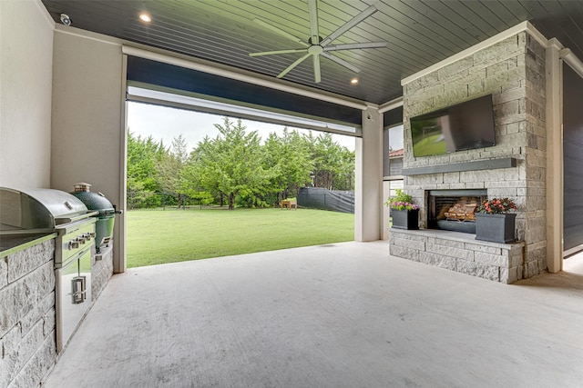 121 Sawgrass Dr, Heath, TX 75032 - fenced backyard featuring an outdoor stone fireplace, a ceiling fan, area for grilling, and a patio
