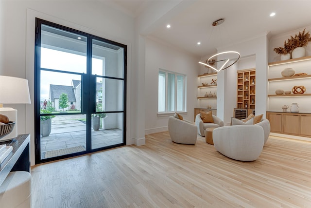 121 Sawgrass Dr, Heath, TX 75032 - living area with a chandelier, light wood-style floors, ornamental molding, and recessed lighting