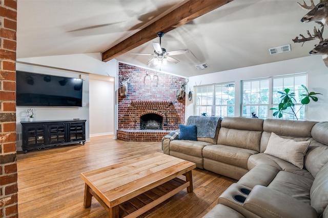 7227 N Stone Meadow Cir, Rowlett, TX 75088 - living area featuring wood finished floors, a ceiling fan, and a fireplace