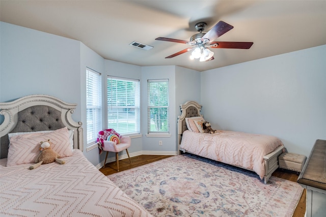 7227 N Stone Meadow Cir, Rowlett, TX 75088 - bedroom with wood finished floors, baseboards, and ceiling fan