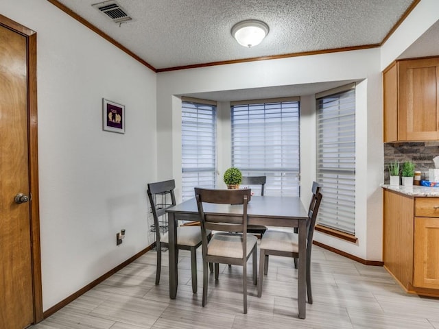 3606 Andrea Ln, Rowlett, TX 75088 - dining room featuring crown molding, baseboards, and a textured ceiling