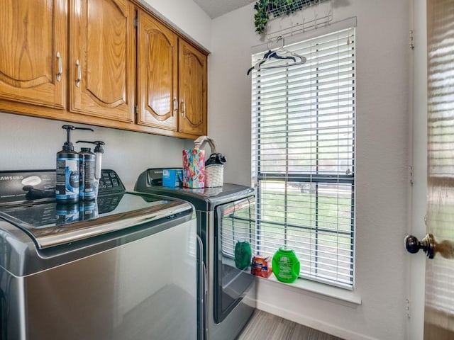 3606 Andrea Ln, Rowlett, TX 75088 - washroom with washing machine and clothes dryer and cabinet space