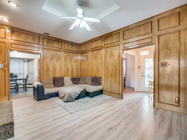 3606 Andrea Ln, Rowlett, TX 75088 - living room with ceiling fan, light wood-style flooring, and wood walls