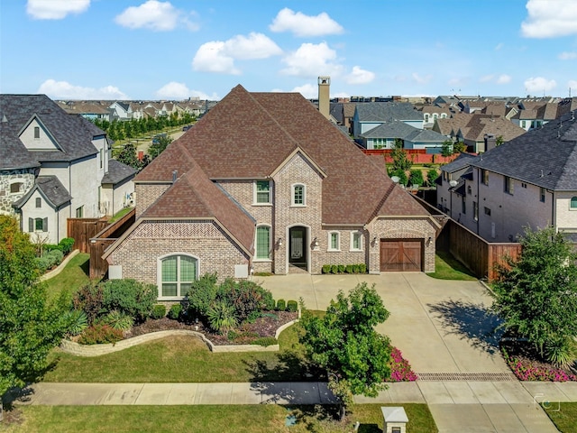 3644 Benchmark Ln, Frisco, TX 75034 - french country style house with brick siding, driveway, a residential view, and an attached garage