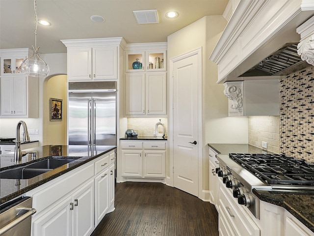 3644 Benchmark Ln, Frisco, TX 75034 - kitchen with stainless steel appliances, wall chimney exhaust hood, white cabinetry, decorative backsplash, and recessed lighting