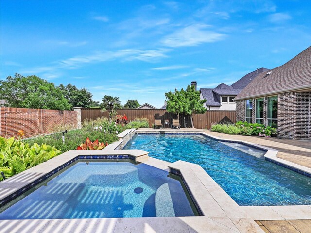 3644 Benchmark Ln, Frisco, TX 75034 - view of swimming pool with a fenced backyard and a pool with connected hot tub