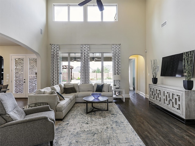 3644 Benchmark Ln, Frisco, TX 75034 - living area featuring a ceiling fan, arched walkways, a high ceiling, dark wood-style flooring, and french doors