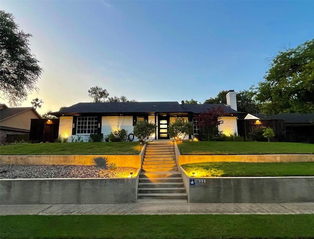1635 W Pentagon Pkwy, Dallas, TX 75224 - view of front of home featuring a chimney, stairs, and a front lawn